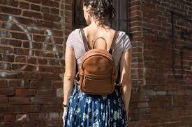 mini backpack purse on the back shoulder of a lady- symbolic pic.